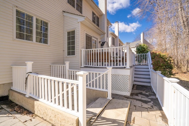 view of side of home featuring stairs and a wooden deck