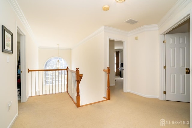 corridor with visible vents, carpet, an upstairs landing, and crown molding