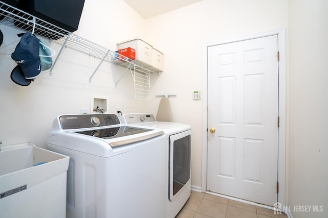 laundry room featuring laundry area, light tile patterned flooring, a sink, and washer and dryer