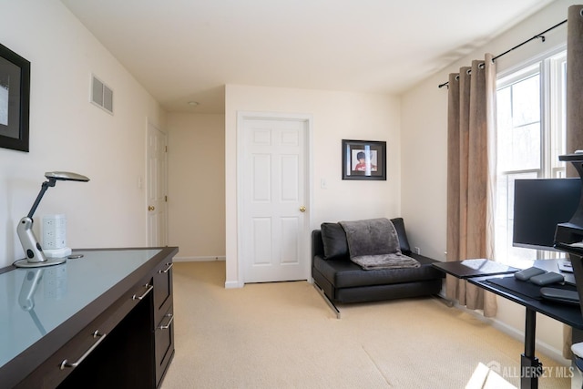 office featuring baseboards, visible vents, and light colored carpet