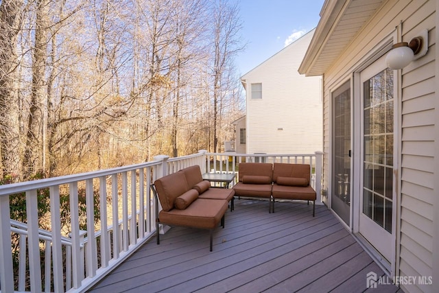 wooden deck with an outdoor living space