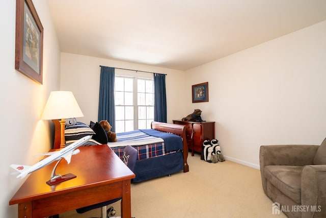 bedroom featuring carpet and baseboards