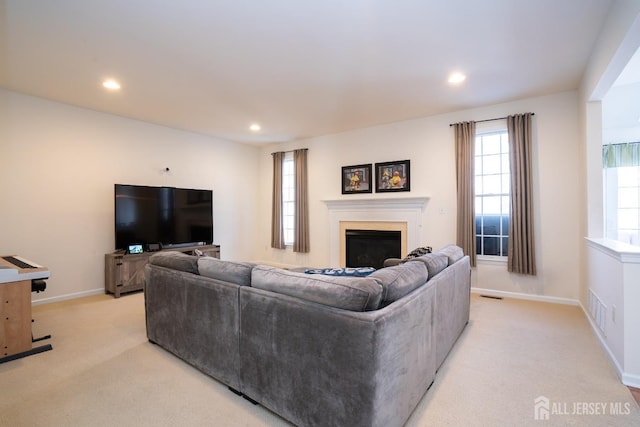 living area featuring a fireplace, recessed lighting, visible vents, light carpet, and baseboards