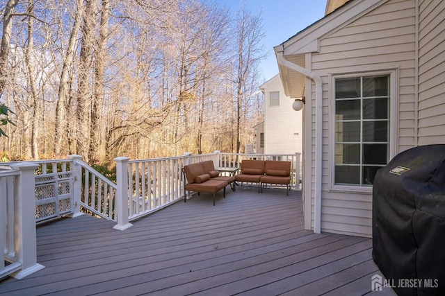 deck featuring an outdoor hangout area and grilling area