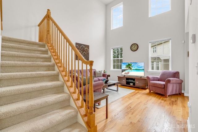 1206 Fir Ct, Franklin Twsp, NJ 08873 - living room featuring light wood-style floors, stairway, and a towering ceiling