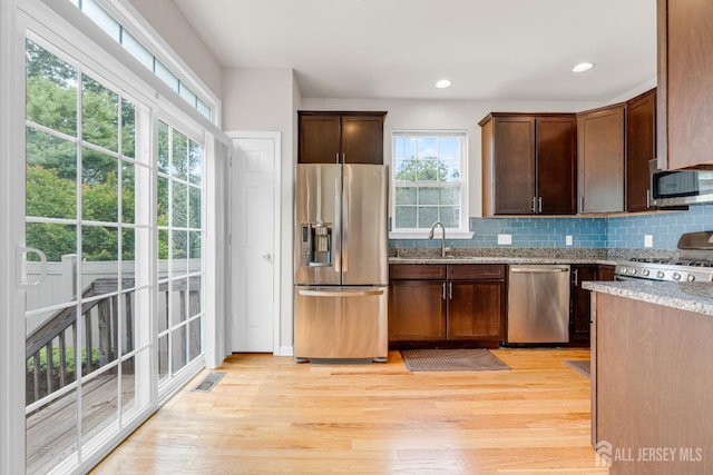 1206 Fir Ct, Franklin Twsp, NJ 08873 - kitchen with appliances with stainless steel finishes, healthy amount of natural light, light stone counters, light wood-style flooring, and recessed lighting