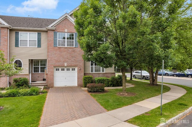 1206 Fir Ct, Franklin Twsp, NJ 08873 - view of front of property with brick siding, an attached garage, a front yard, and decorative driveway