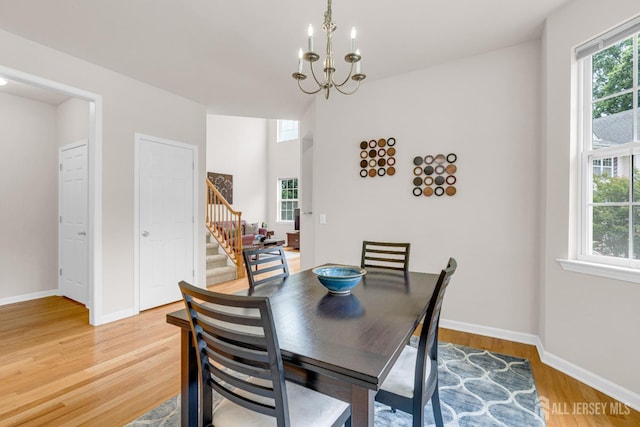 1206 Fir Ct, Franklin Twsp, NJ 08873 - dining space featuring stairway, light wood-type flooring, and a chandelier