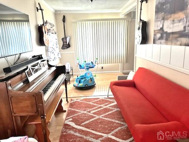 miscellaneous room featuring crown molding and hardwood / wood-style flooring