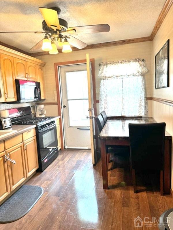 kitchen with black appliances, ceiling fan, ornamental molding, a textured ceiling, and dark hardwood / wood-style flooring