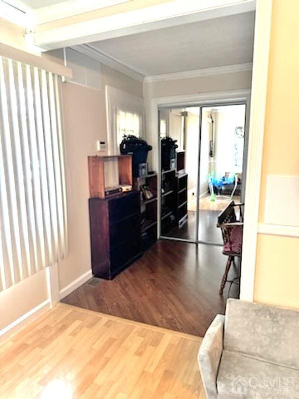 interior space featuring crown molding and wood-type flooring