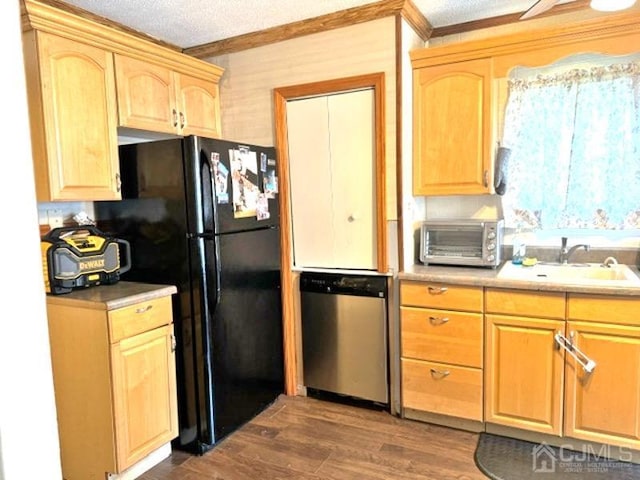 kitchen featuring dishwasher, sink, black fridge, dark hardwood / wood-style floors, and a textured ceiling