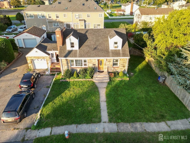 view of front of property featuring a front yard, fence, a chimney, stone siding, and a residential view