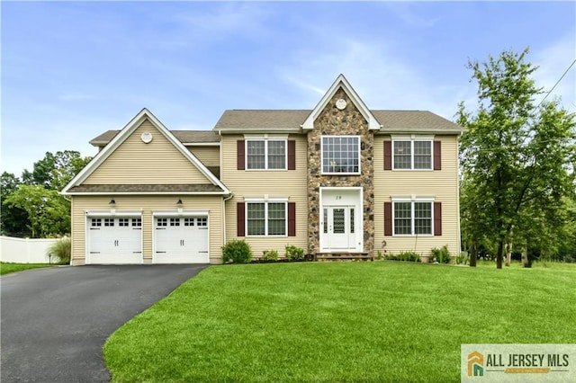 19 Maplehurst Ln, Piscataway, NJ 08854 - view of front facade with asphalt driveway, a garage, and stone siding