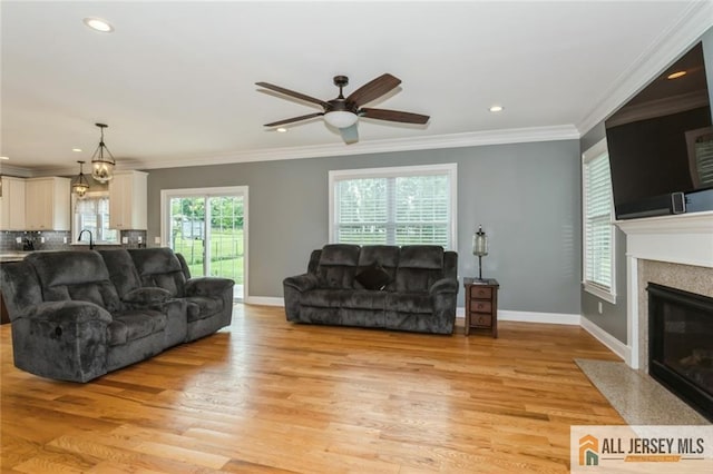 19 Maplehurst Ln, Piscataway, NJ 08854 - living area featuring ceiling fan, a fireplace with flush hearth, light wood finished floors, ornamental molding, and recessed lighting