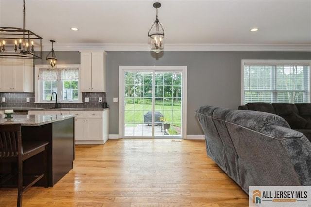 19 Maplehurst Ln, Piscataway, NJ 08854 - kitchen with open floor plan, white cabinetry, light stone countertops, ornamental molding, and recessed lighting