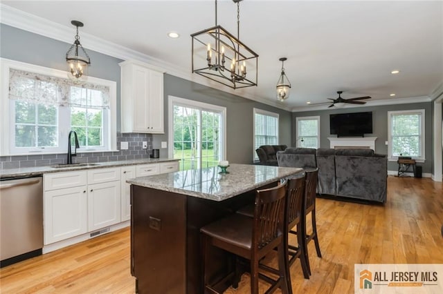 19 Maplehurst Ln, Piscataway, NJ 08854 - kitchen featuring stainless steel dishwasher, a chandelier, ornamental molding, light stone countertops, and a ceiling fan