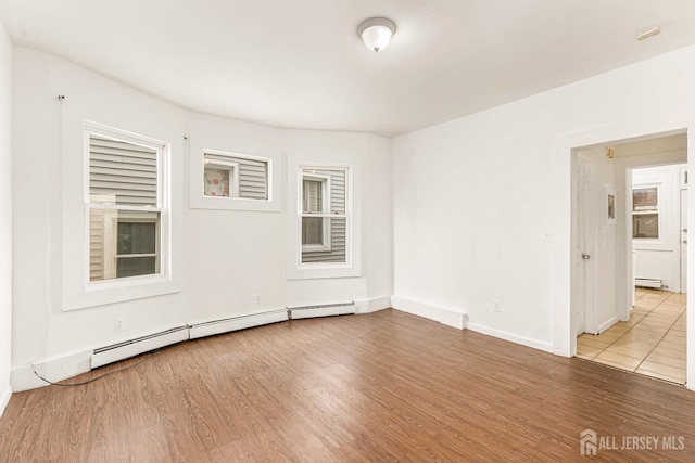 107 N 16th St N, East Orange, NJ 07017 - spare room featuring wood finished floors, a baseboard heating unit, and baseboards