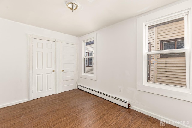 107 N 16th St N, East Orange, NJ 07017 - unfurnished bedroom with a baseboard heating unit, wood finished floors, and a closet