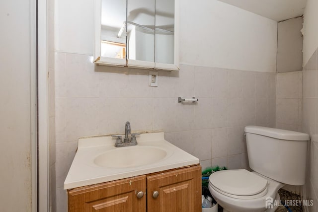 107 N 16th St N, East Orange, NJ 07017 - half bathroom featuring tile walls, toilet, and vanity