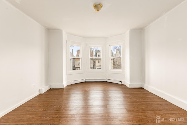 107 N 16th St N, East Orange, NJ 07017 - spare room with dark wood finished floors, a baseboard radiator, and baseboards