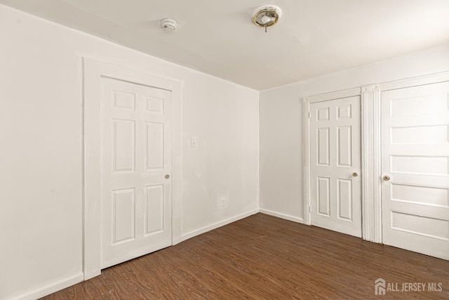 107 N 16th St N, East Orange, NJ 07017 - unfurnished room featuring dark wood-type flooring, a smoke detector, and baseboards