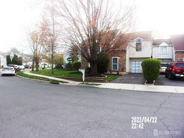 29 Jeffrey Cir S, Brunswick, NJ 08810 - view of front facade with an attached garage, asphalt driveway, and a front lawn
