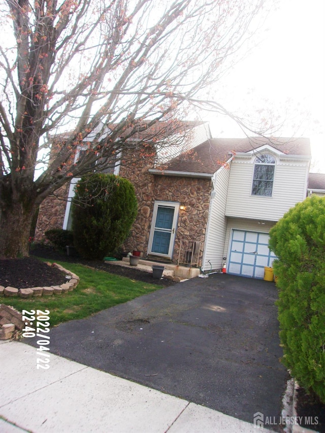 29 Jeffrey Cir S, Brunswick, NJ 08810 - view of front facade featuring stone siding, driveway, and an attached garage