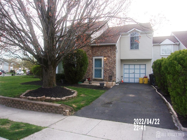 29 Jeffrey Cir S, Brunswick, NJ 08810 - view of front facade featuring stone siding, an attached garage, asphalt driveway, and a front lawn