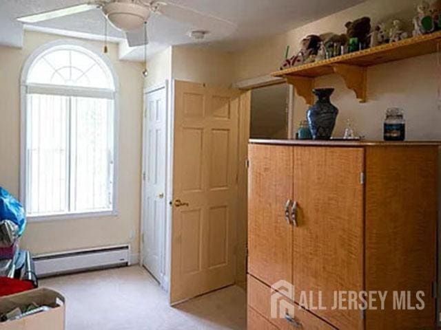 29 Jeffrey Cir S, Brunswick, NJ 08810 - bedroom with a baseboard heating unit and multiple windows