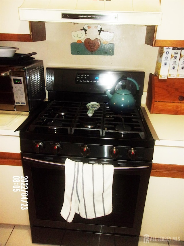 29 Jeffrey Cir S, Brunswick, NJ 08810 - kitchen view of black range with gas cooktop, extractor fan, and light countertops