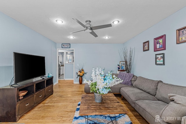 living room with a ceiling fan, baseboards, recessed lighting, and light wood finished floors