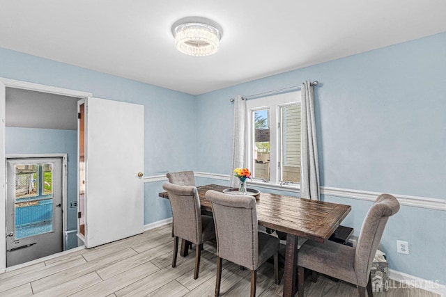 dining space with baseboards, wood tiled floor, and a wealth of natural light