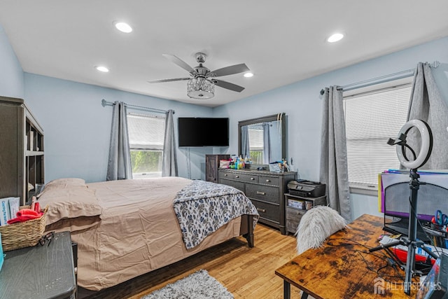 bedroom with light wood-style floors, multiple windows, and recessed lighting