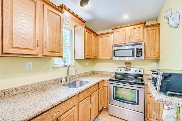 151 N Broadway N, South Amboy, NJ 08879 - kitchen with stainless steel appliances, a sink, light stone countertops, light wood-style flooring, and light brown cabinets