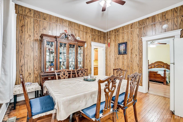 151 N Broadway N, South Amboy, NJ 08879 - dining area featuring ceiling fan, light wood-type flooring, wood walls, and ornamental molding