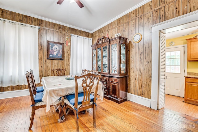 151 N Broadway N, South Amboy, NJ 08879 - dining room featuring light wood finished floors, a ceiling fan, wooden walls, baseboards, and crown molding
