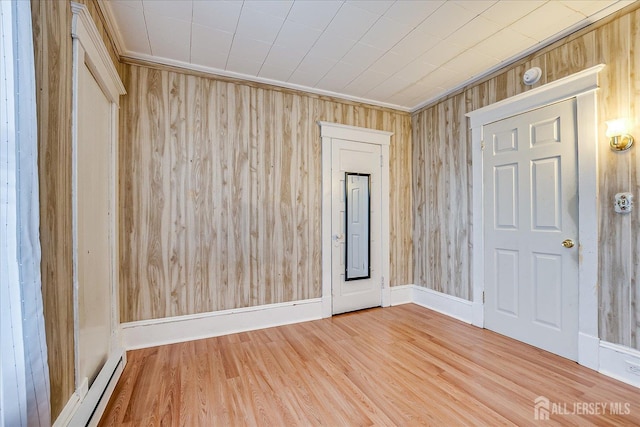 151 N Broadway N, South Amboy, NJ 08879 - empty room featuring wood finished floors, wooden walls, and a baseboard radiator