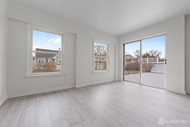 unfurnished room with light hardwood / wood-style flooring