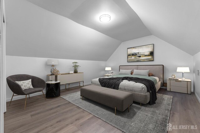 bedroom with hardwood / wood-style floors and vaulted ceiling