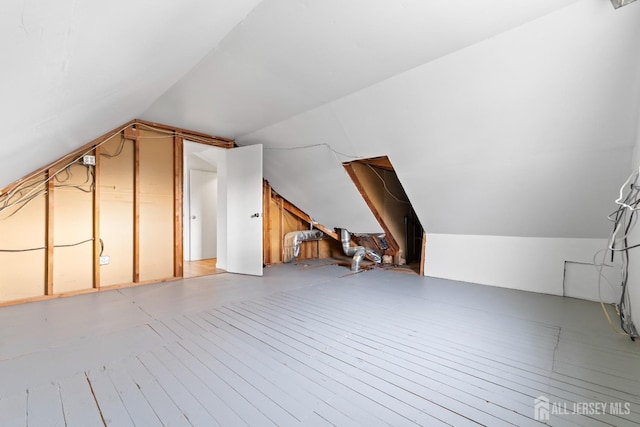 additional living space featuring lofted ceiling