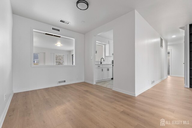 spare room featuring light hardwood / wood-style floors and sink