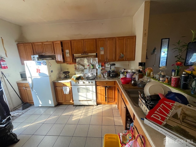 83 Throop Ave, New Brunswick, NJ 08901 - kitchen featuring white appliances, under cabinet range hood, light countertops, and brown cabinets