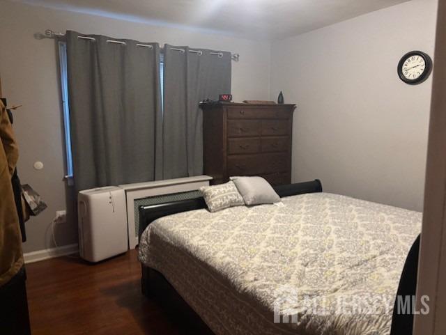 bedroom featuring dark hardwood / wood-style flooring