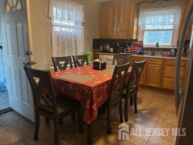 dining space with tile patterned flooring and sink