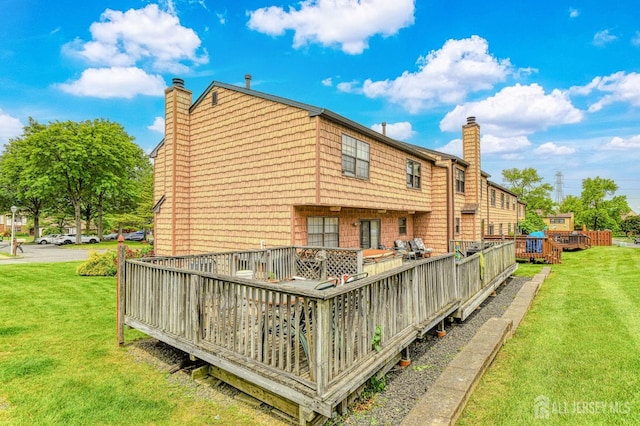 21 Wellington Ct, Sayreville, NJ 08872 - back of property featuring a chimney, a lawn, and a wooden deck