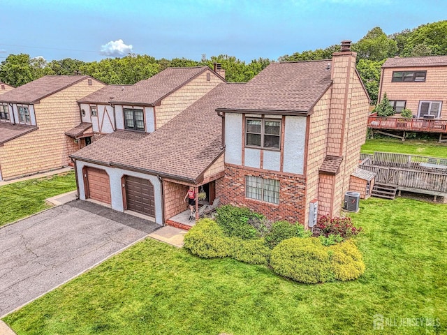 21 Wellington Ct, Sayreville, NJ 08872 - english style home with a chimney, asphalt driveway, an attached garage, a front yard, and roof with shingles