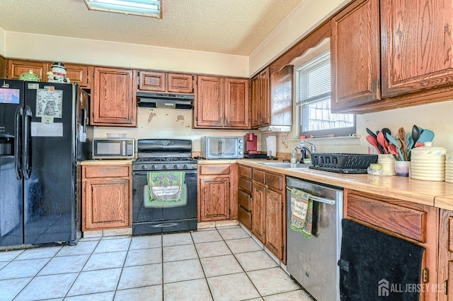 21 Wellington Ct, Sayreville, NJ 08872 - kitchen with black appliances, under cabinet range hood, brown cabinets, light countertops, and a textured ceiling