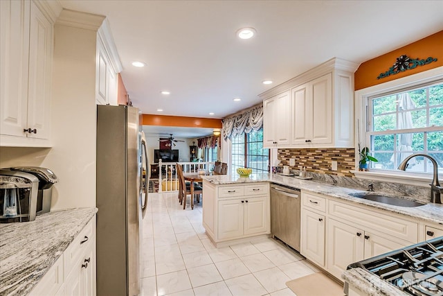 10 Dellview Dr, Edison, NJ 08820 - kitchen with stainless steel appliances, a ceiling fan, a peninsula, recessed lighting, and light stone countertops