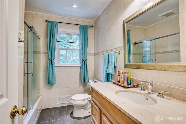 10 Dellview Dr, Edison, NJ 08820 - bathroom with tile walls, tile patterned flooring, vanity, and combined bath / shower with glass door